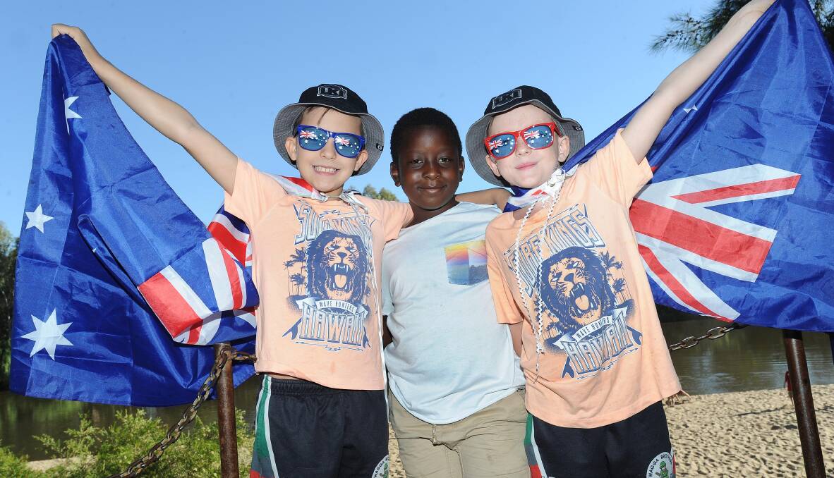 FLYING THE FLAG: Luke Anderson, Alexander Yongai and Trent Anderson celebrate last year's Australia Day at Wagga Beach. Picture: Laura Hardwick