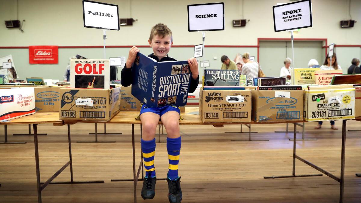 SUCCESS: Gerry Page, of the Rotary Club of Wagga Wagga, thanks all those who supported the recent book fair. Joel Wheeler, 7, was just one of the attendees.