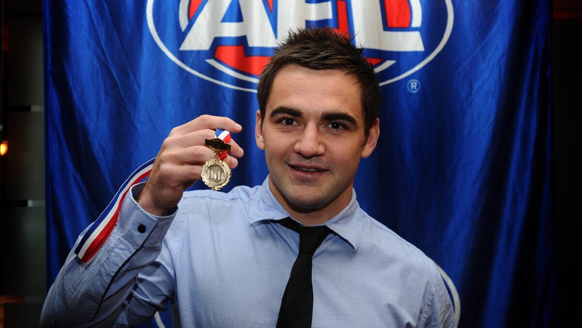 Langtry with his second Clear Medal, when he was a joint winner in 2011, a year after he'd won the league best-and-fairest outright.