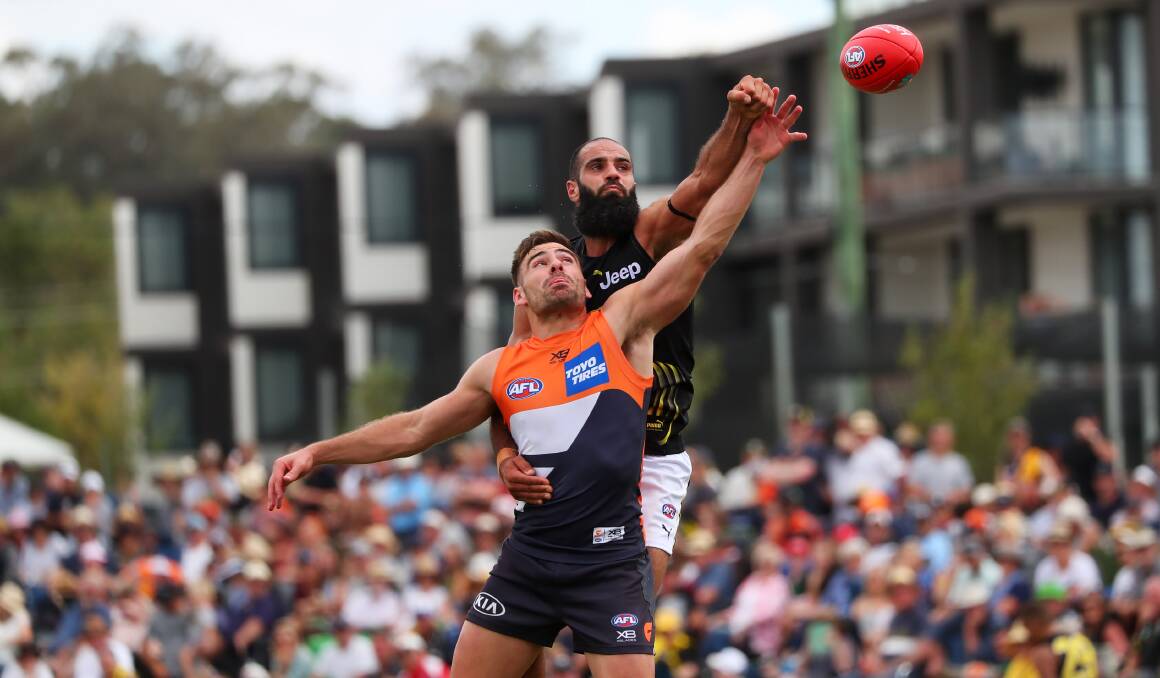 FIERCE BATTLE: Two of the AFL's superstars, GWS captain Stephen Coniglio and Richmond 200-gamer Bachar Houli in action in Wagga on Sunday. Picture: Emma Hillier