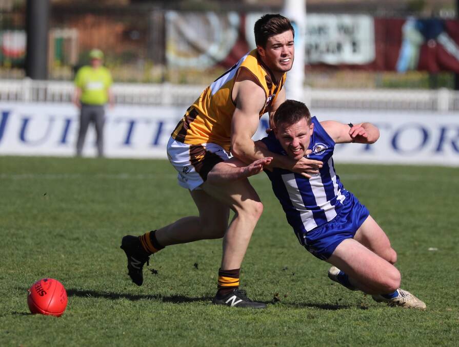 TOUGH BATTLE: Hawks' Harry Fitzsimmons tries to keep Temora's Sam Jensen from the footy in Sunday's sudden death semi-final. Jensen was among the Roos' best in their narrow win. Picture: Les Smith