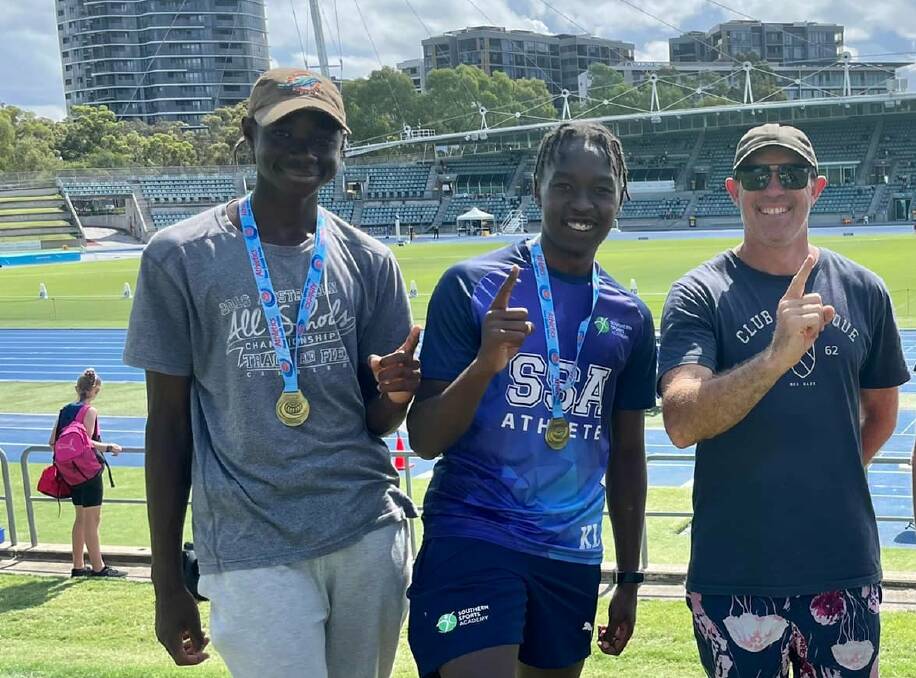 CHASING A FEELING: Temora coach Greg Wiencke with Wagga jumpers Daniel Okerenyang (far left) and Kippy Langat. Pictures: Temora Little Athletics