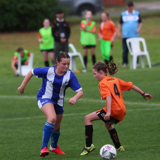 Katie Blake (Tolland) and Ella Fairman (Wagga United) in the under 12-14 girls grand final at Gissing Oval last Saturday. Pictures: Emma Hillier