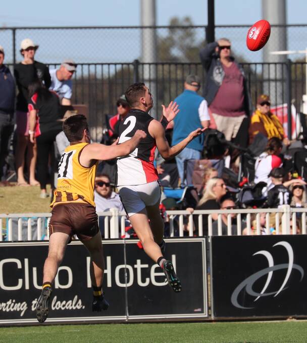 North Wagga's Troy Curtis goes up for a mark in last year's grand final. The Saints' premiership defence remains on hold as AFL Riverina awaits direction.
