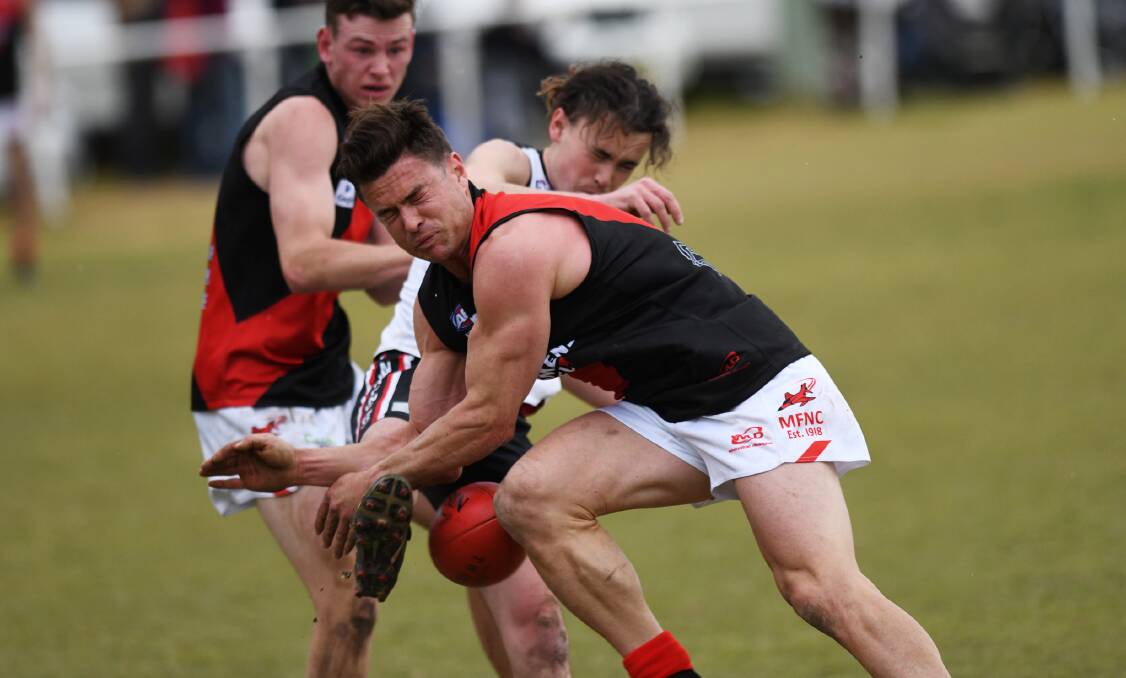 INTENSITY: Marrar's Truman Carroll commits to the contest in this encounter with North Wagga's Jackson Kerr. Carroll set the tone as the Bombers rode home on the back of pressure for an important win. 