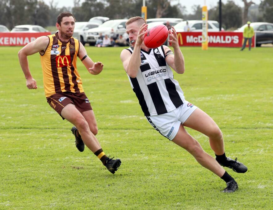FLYING START: The Rock-Yerong Creek forward Joey Kerin gets a touch in front of EWK's Matt Beasley in the Magpies' opening round win. Picture: Les Smith