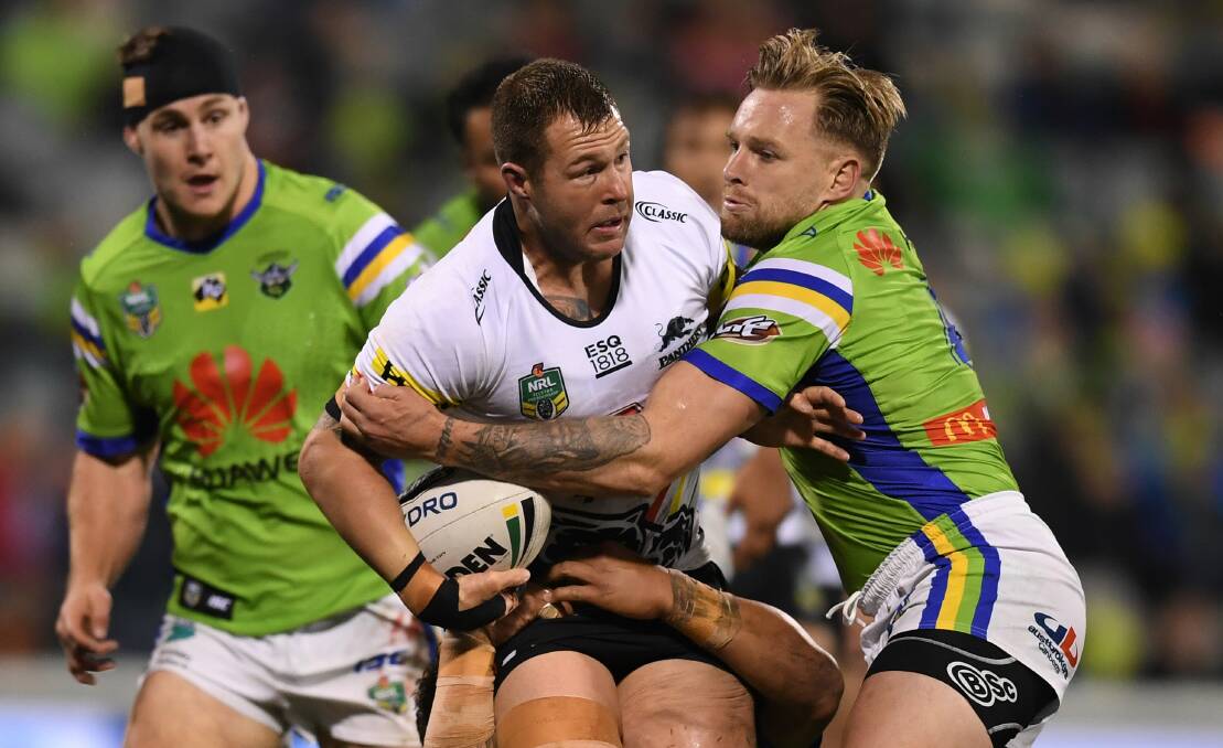 The Raiders trying to wrap up Penrith forward Trent Merrin. Picture: AAP