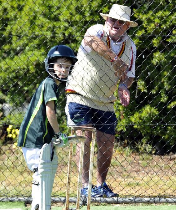 'BAT, AND BAT, AND BAT': Esteemed cricket coach Warren Smith offers advice to Albury's Luke Sampson at a Wagga coaching clinic last year. Smith wants players to concentrate on occupying the crease, not runs. Picture: Les Smith