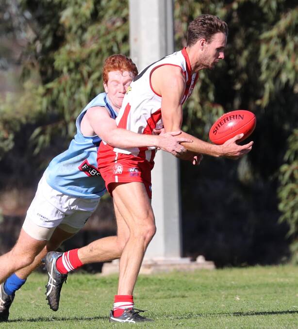PRESSURE ON: Bushpigs forward Joe Stapleton has Barellan's Shaun Bourchier hot on his tail in the first half of their Farrer League fixture at Peter Hastie Oval on Saturday.
 