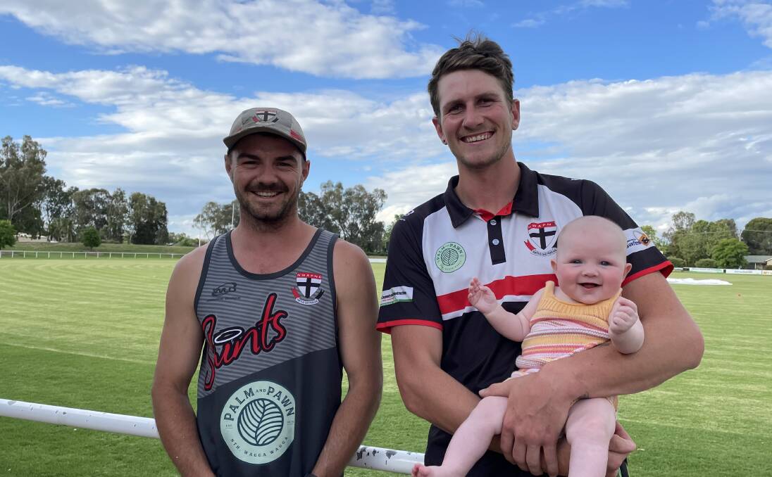 ALL SMILES: North Wagga coach Cayden Winter welcomes new ruckman Matt Parks and his daughter Stella, four months, to McPherson Oval. Picture: Peter Doherty