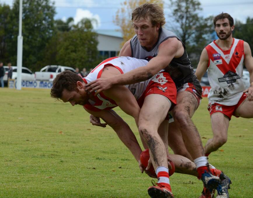 Heath Northey is pursued by Matt Klemke in the teams' meeting at Griffith earlier this year. The Swans midfielder was superb on that occasion.