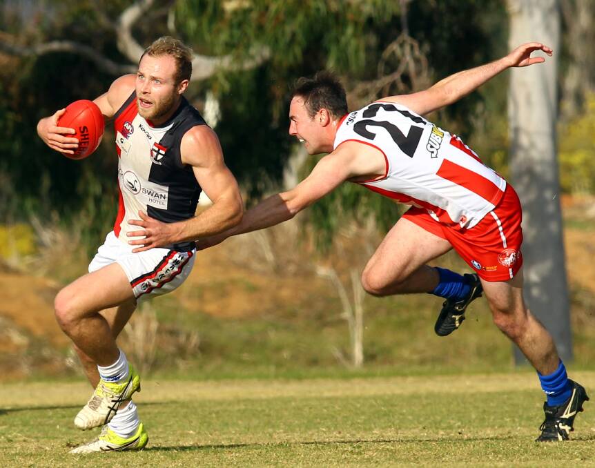 CLUTCHING: North Wagga midfielder Lachie Highfield leaves CSU's Clay Hamblin in his wake during the Saints' convincing win. Picture: Les Smith