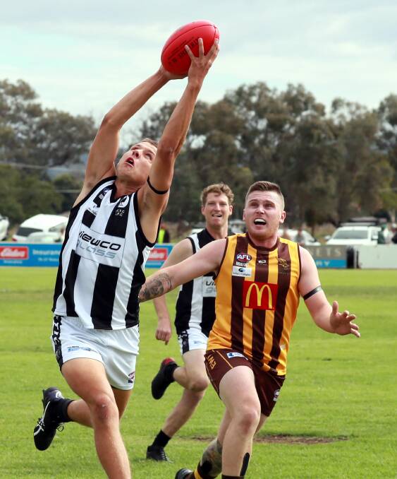 STRONG DISPLAY: The Rock-Yerong Creek's Cooper Diessel marks in front of Hawk Ethan Andrews at Gumly on Saturday. Diessel was among the Magpies' best in their opening round win. Picture: Les Smith