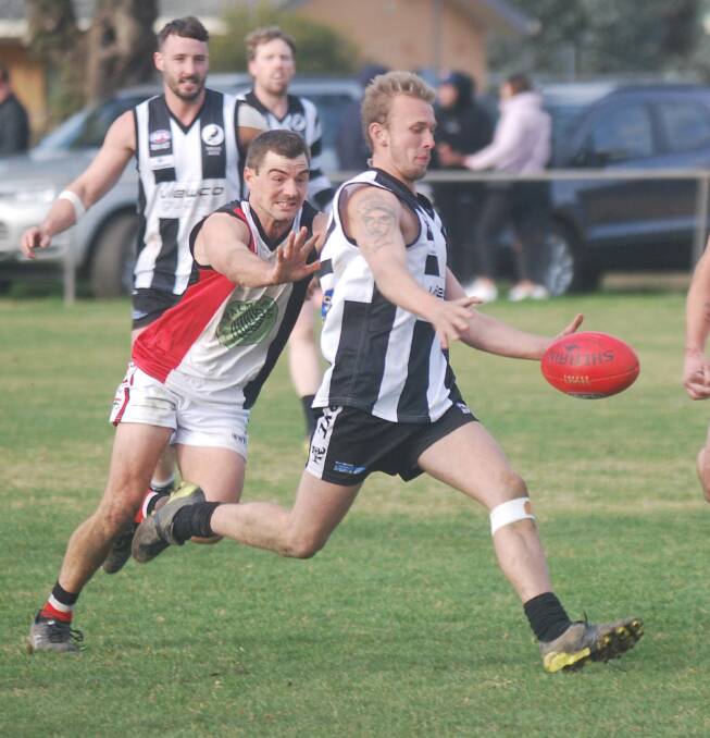 Cayden Winter desperately tries to stop Tom Collins getting boot to ball but the Magpie, in his second senior game - kicked his first goal of the year. 