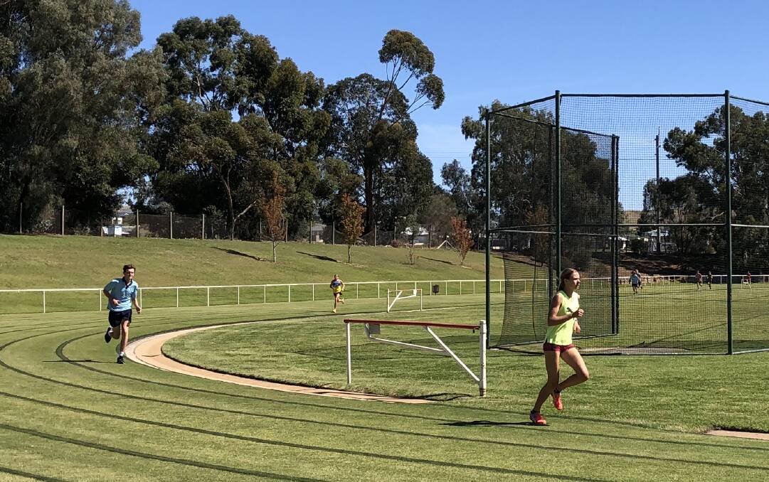 ON THE MOVE: 15 years girls age champion, Charlotte Priest, steals a break on Ethan Drum and Emma Devries on her way to a record-breaking win in the 800m at the Mater Dei Catholic College athletics carnival on Wednesday.