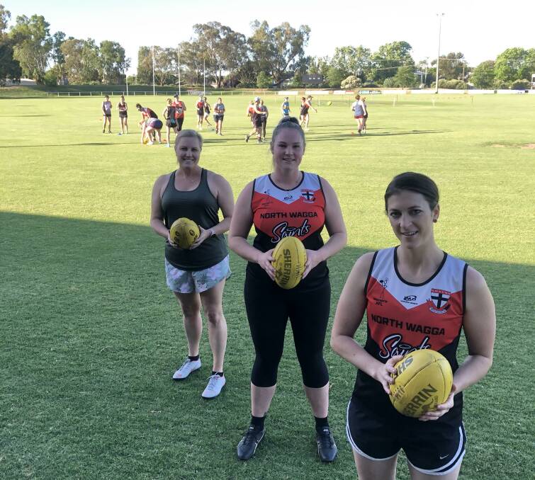 STRONG INTEREST: North Wagga's women's football coordinator Sarah Harmer (right) with new Saint Helen FIsher (left) and returning star Skye Davey at training at McPherson Oval this week. Picture: Peter Doherty