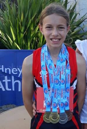 Grace with her two golds, a silver and a bronze medal