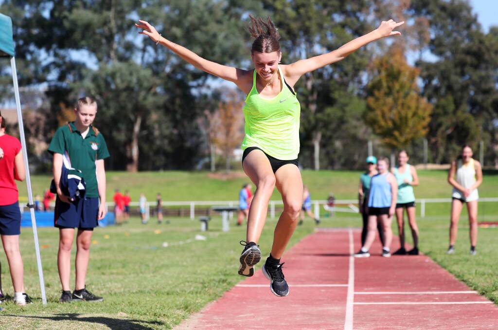 SPREADING WINGS: Morgan Jolliffe, 15, gets some good air in the long jump at The Riverina Anglican College athletics carnival on Friday. Picture: Emma Hillier