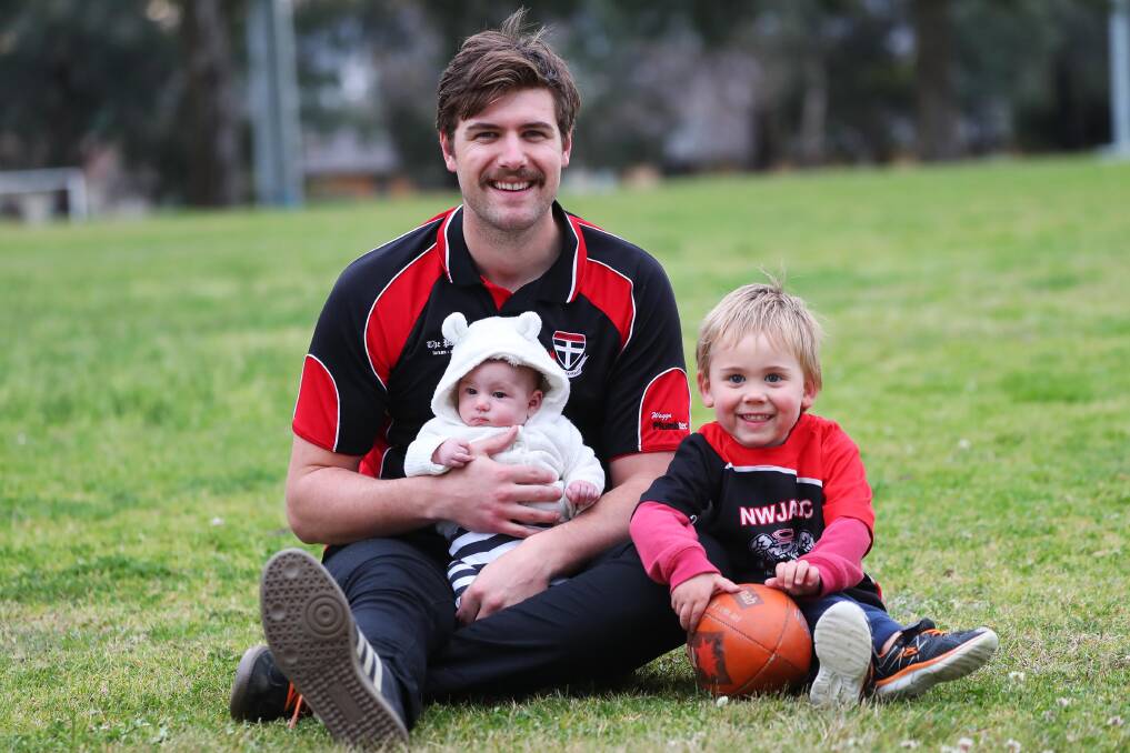BIGGEST FANS: North Wagga forward Daniel Jordan takes a break in grand final week with six-week-old daughter Darcy and son Oliver, 3. Picture: Emma Hillier