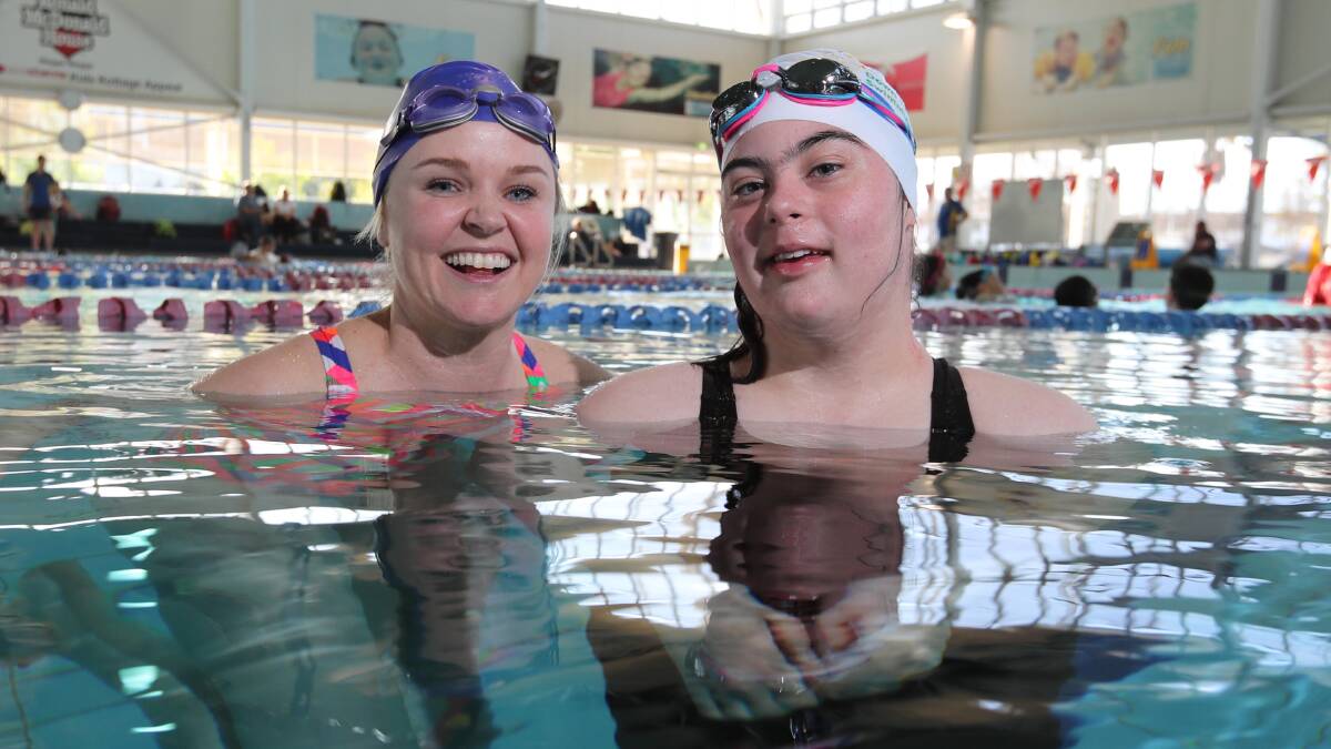 CHAMPION TEAM: Gretta Leigh-Cooper (right) in the pool at Oasis this week with her coach, Emily Paul. Picture: Les Smith