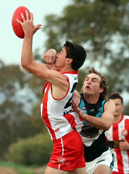 KISS THIS: CSU's Will Stewart marks despite the best efforts of Jets' Mitch Doyle. Picture: Les Smith