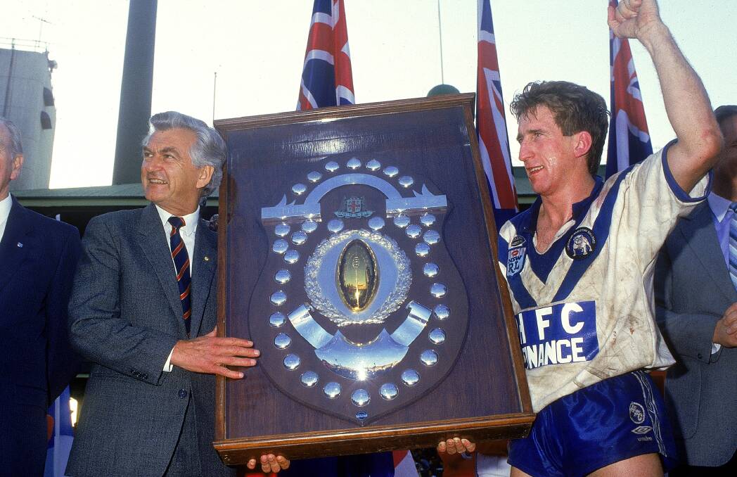 Steve Mortimer captained Canterbury to premiership glory in 1985. He is presented with the shield by Prime Minister Bob Hawke. Picture: Getty Images