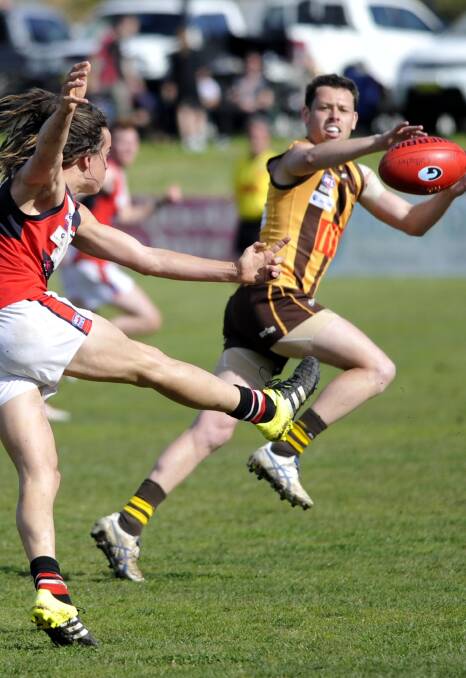 TOUGH ENCOUNTER: North Wagga's Ben Alexander gets his kick away at Maher Oval in front of East Wagga-Kooringal's Kassidy Argus. Picture: Les Smith