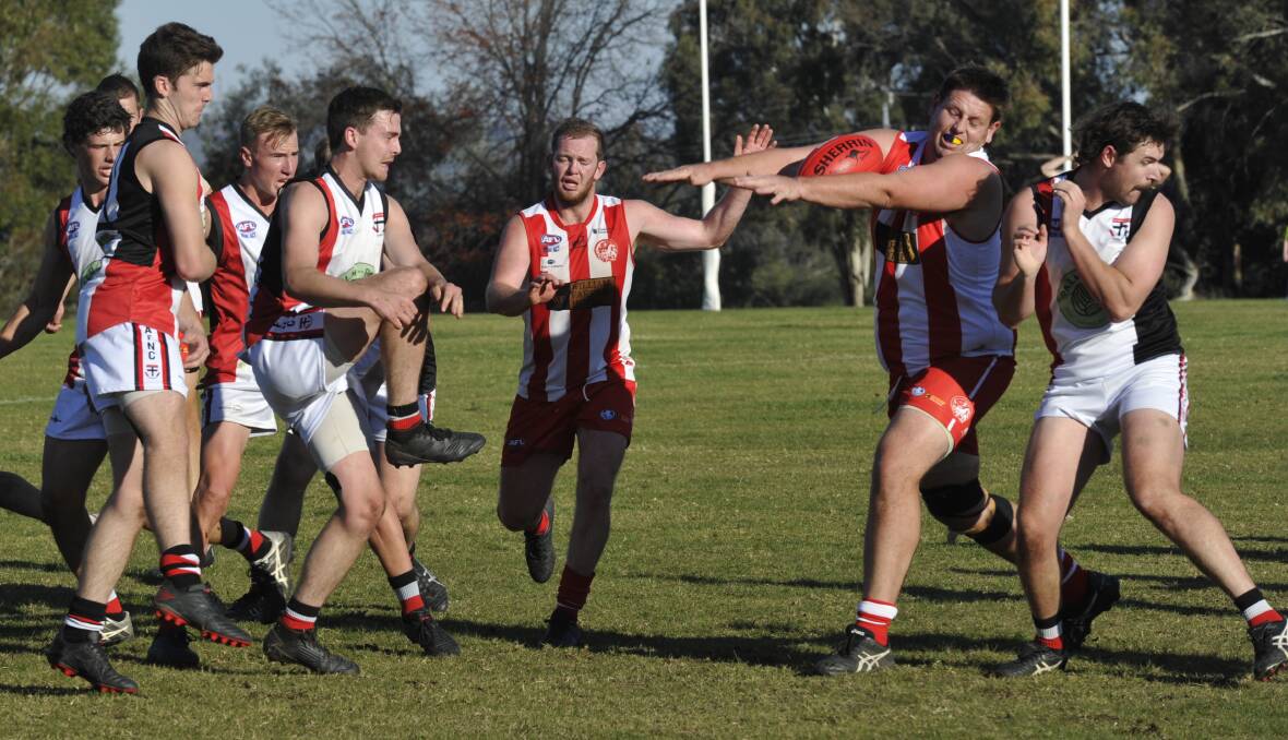 SMOTHER: CSU's Andrew Dickins prevents Ben Keith's kick from driving North Wagga into the attack at Peter Hastie Oval on Saturday. Picture: Peter Doherty