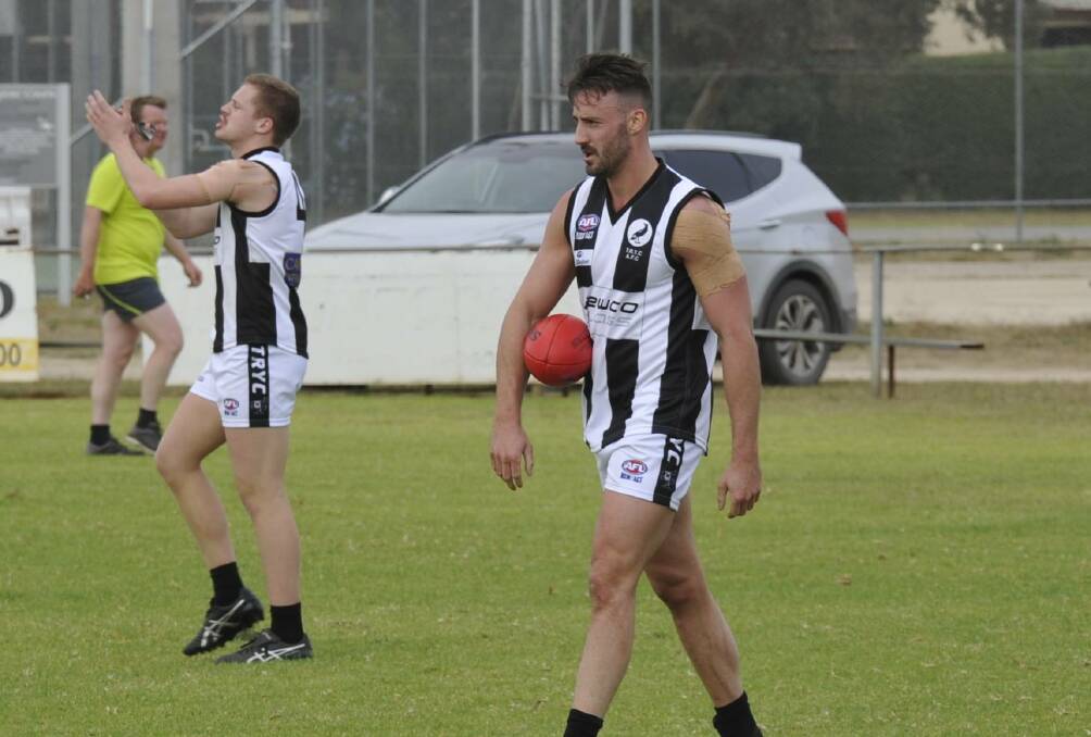 WALKING THE WALK: The Rock-Yerong Creek forward Dean Biermann about to kick his fourth goal after another mark against the Jets. Teammate Joey Kerin congratulates teammates up field on their delivery into the forward line. The pair shared 11 goals last week. Picture: Peter Doherty