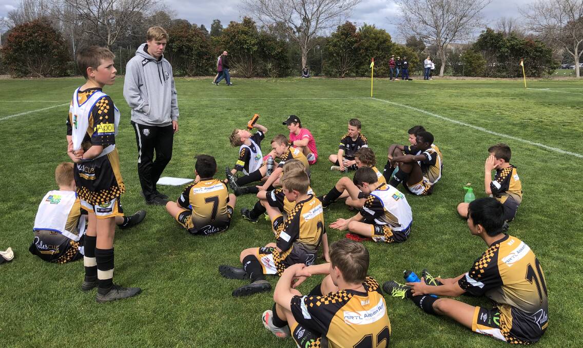 PEP TALK: Wagga City Wanderers' under 13s boys coach Kyle Yeates addresses his troops at half-time in Canberra last weekend. They salvaged a 3-3 draw against Canberra Olympic.