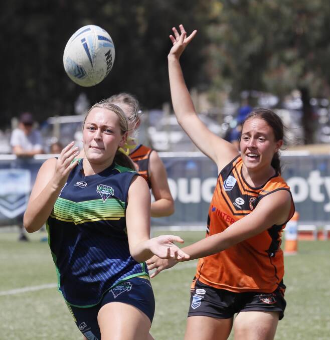 QUALITY TOUCH: Wagga's Ash Reynoldson fires out a pass in the under 18 girls final on Sunday. Picture: Les Smith