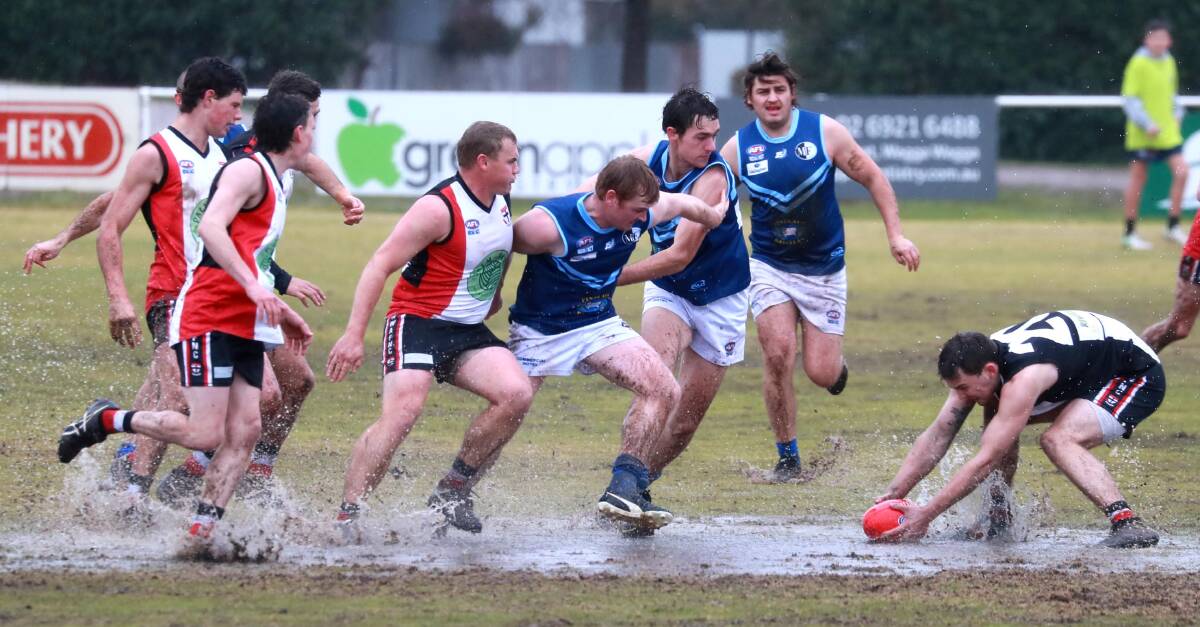 WIDE SPECTRUM: Barellan's visit to a wet North Wagga last year. The two clubs illustrate the variety of clubs, all with differing concerns and priorities, in the one league. Saints are a club worried about losing too many under 17.5 players to Riverina League clubs while Barellan don't field a third grade. 