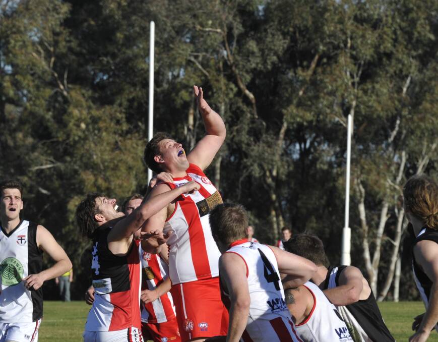 BATTLE: CSU's Andrew Dickins competes with North Wagga's Daniel Jordan. Picture: Peter Doherty