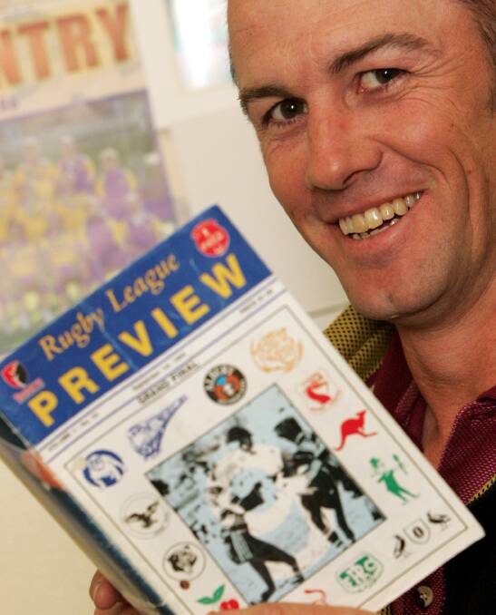 INSPIRATION: The late Rick Keast in 2007, looking back at the 1995 grand final program.