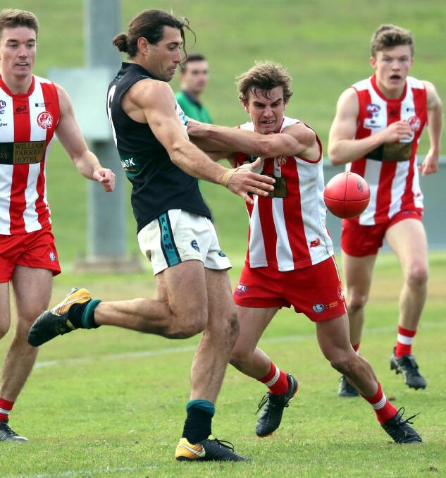 QUALITY AND CONSISTENCY: Northern Jets coach Mitch Haddrill and CSU midfielder Lachie Moore do battle. The pair epitomised the efforts of those in the league's team of the year with their ability, reliability and professional approach. Picture: Les Smith