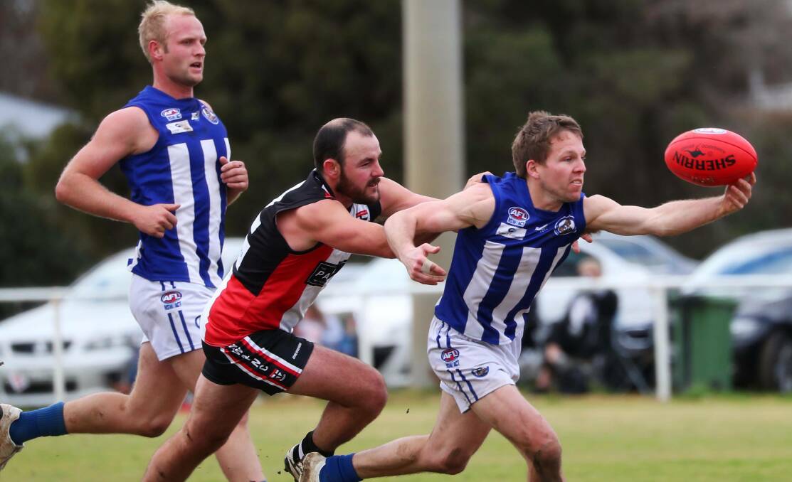 BIG TEST: Roos midfielder Sam Jensen tries to escape the clutches of North Wagga's Lachlan Steward in Temora's last loss to the Saints. Picture: Emma Hillier