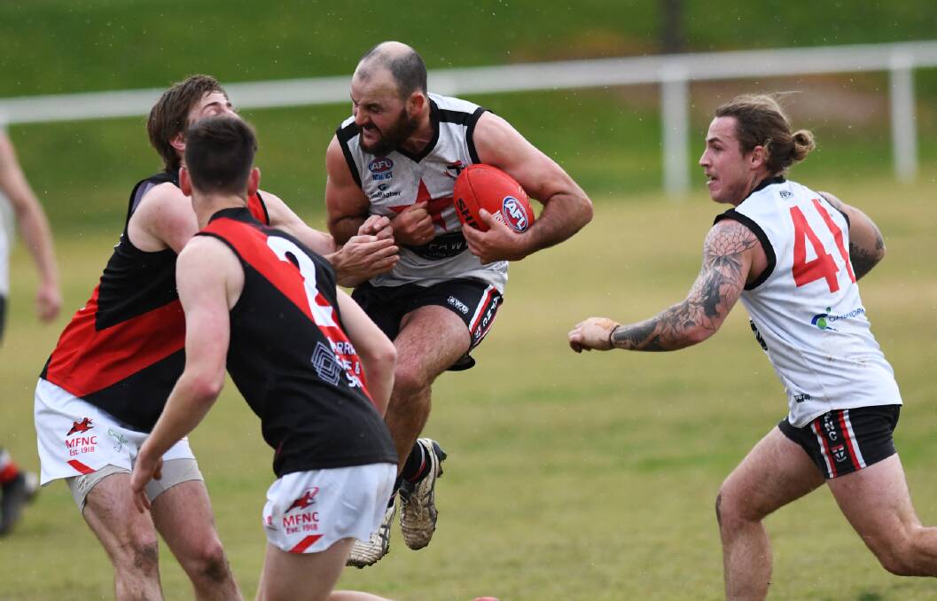 North Wagga's Lachlan Steward braces for impact in the first quarter against Marrar at McPherson Oval