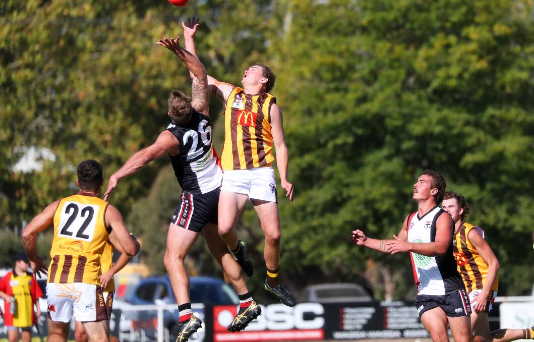 RIVALRY: North Wagga and East Wagga-Kooringal ruckmen Drew Mitchell (26) and Caleb Wild battle it out in the first of the rivals' local derbies early this year. 