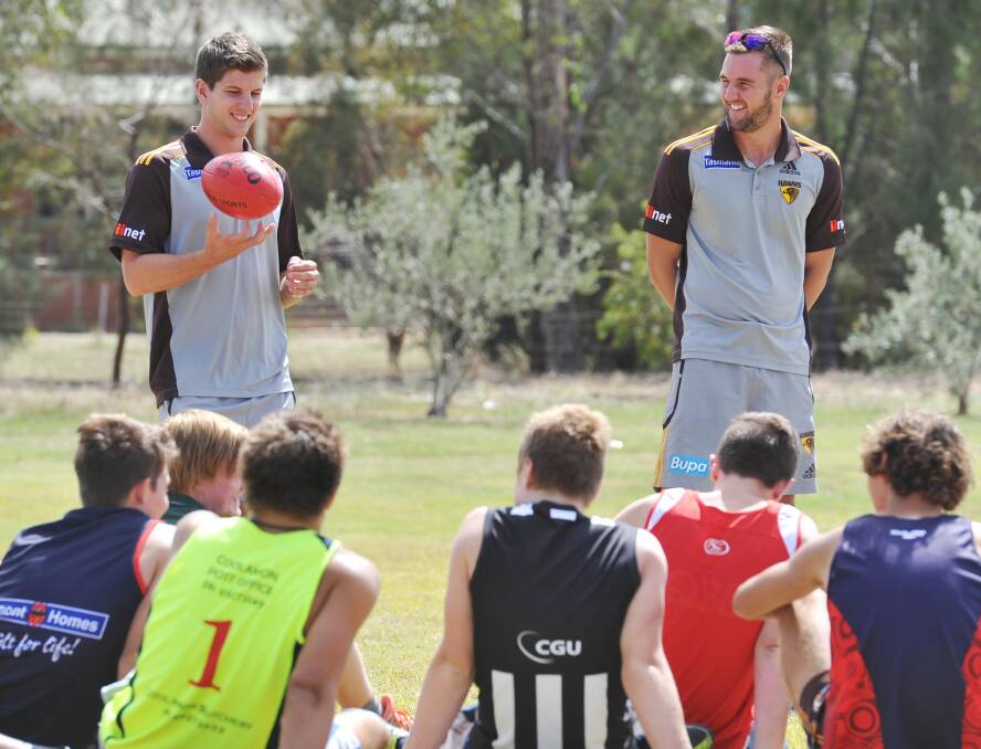 Luke Breust at a school clinic in Wagga in 2013 with then teammate Matt Suckling, who has just retired from AFL. 