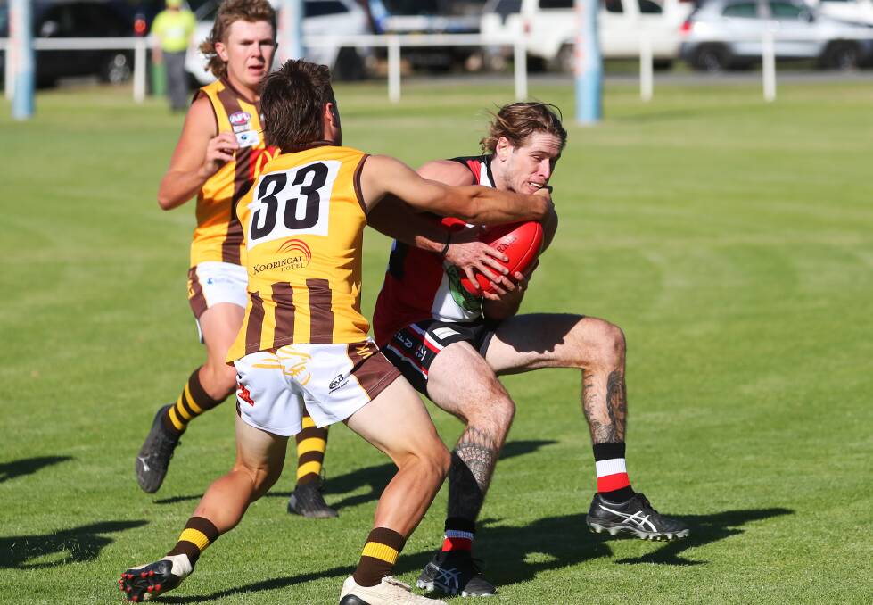 PRESSURE: East Wagga-Kooringal's Harry Fitzsimmons gives North Wagga's Corey Watt no peace in Saturday's derby at McPherson Oval. Picture: Emma Hillier