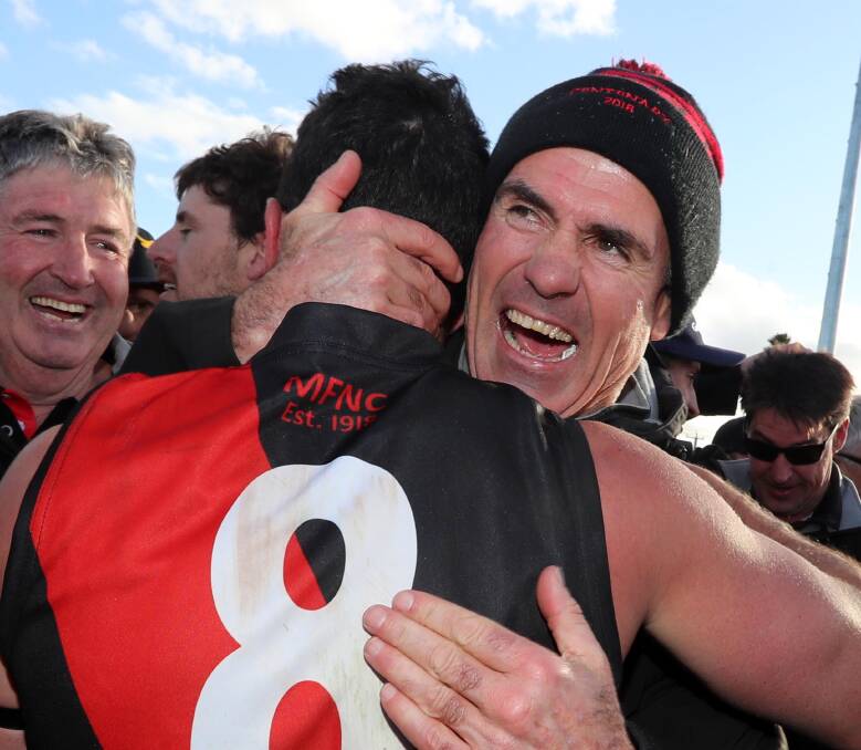 Marrar coach Shane Lenon celebrates with Curtis Allen after a second straight premiership victory for the Bombers, as a smiling John Carroll (now club president) enjoys the moment. Picture: Les Smith