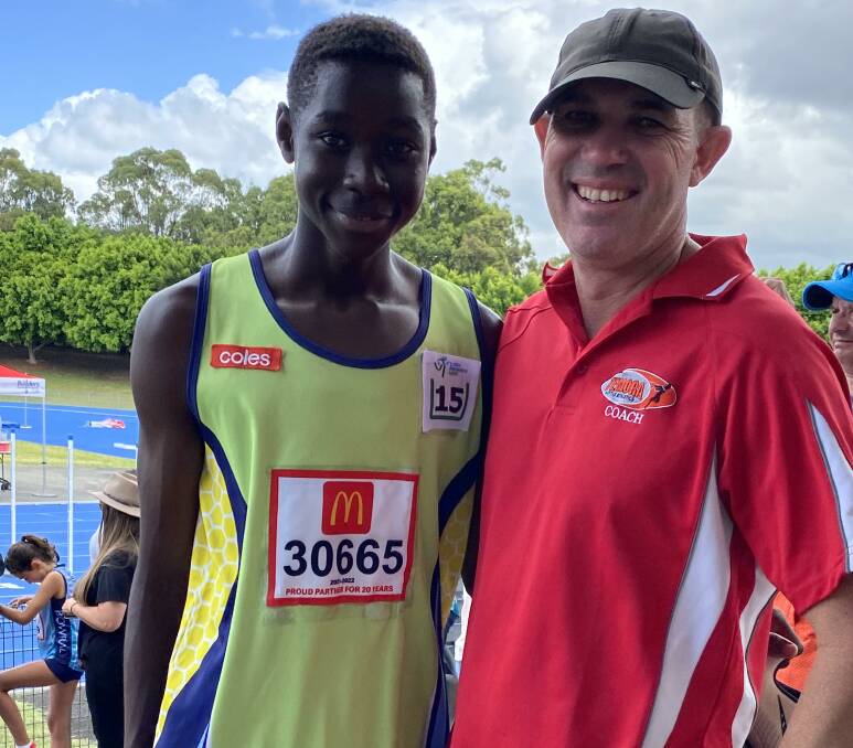 TRIPLE GOLD: Kooringal-Wagga athlete Daniel Okerenyang at Regional Championships with coach Greg Wiencke, from Temora, whose Little Athletics club also shone.