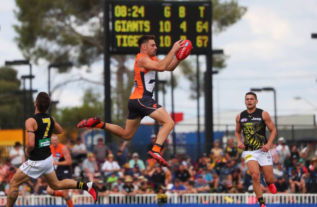FREE-FLOWING AFFAIR: GWS captain Stephen Coniglio takes a mark early in the third quarter against Richmond on Sunday, shortly after the Tigers had reclaimed the lead. Picture: Emma Hillier
