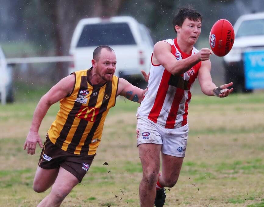 TOUGH ENCOUNTER: EWK's Danny Bromham closes in on Bushpig Louis Miller in the Hawks' win at Gumly on Saturday. Picture: Emma Hillier
