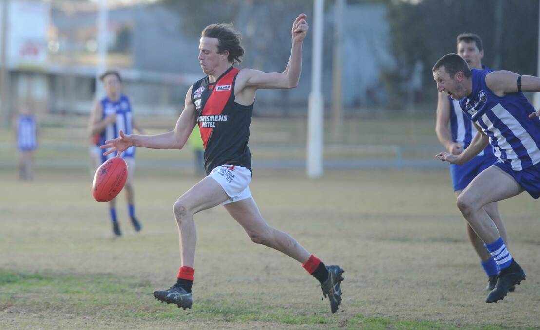 ON THE RUN: Marrar's Jed Jenkins kicks on goal as Temora's Chase Grintell tries in vain to close the gap at Nixon Park on Saturday.
