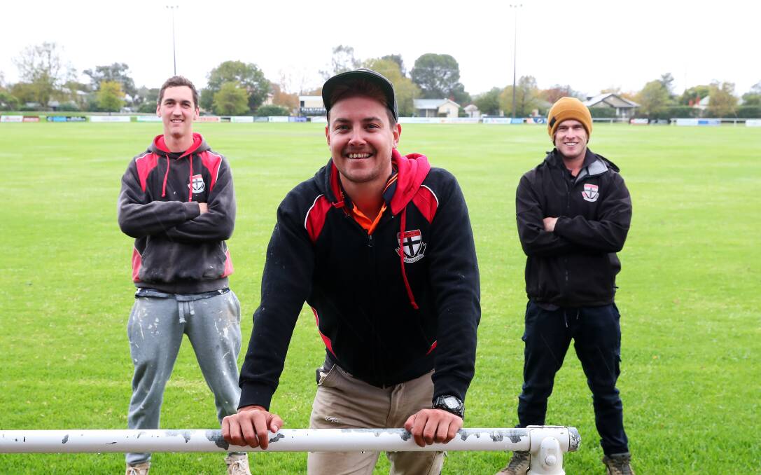 GOOD TIMES: North Wagga assistant coach Ben Alexander flanked by premiership teammates Troy Curtis (left) and Corey Watt at McPherson Oval. Picture: Emma Hillier