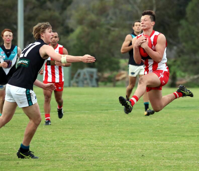 FLYING PIG: Northern Jets' Nathan Tiyce can't stop Lou Miller from marking in CSU's win at Peter Hastie Oval on Saturday. Picture: Les Smith