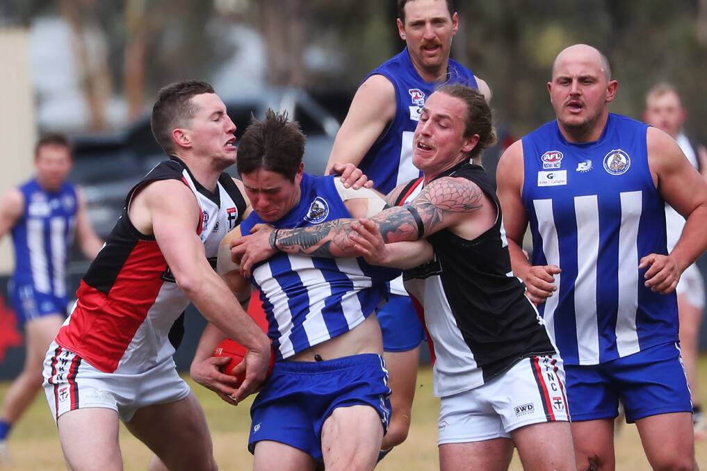 TIGHT REIN: North Wagga's Tom Bennetts (left) and Jake May shut down Temora's Rob Krause in the Saints' win at Nixon Park on Saturday. Picture: Emma Hillier