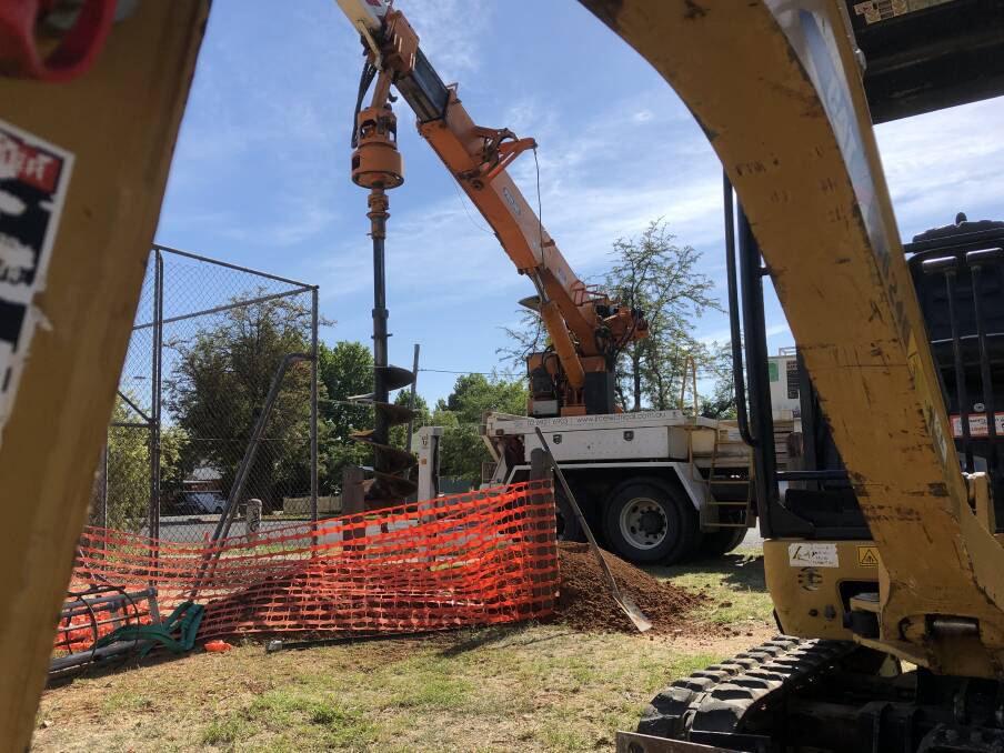 Work begins to move the light poles at the South Wagga courts. Picture: Peter Doherty