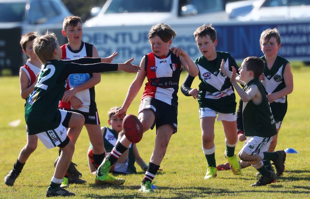 OUT OF TROUBLE: North Wagga's Jett Grentell gets a kick and clears the congestion against Coolamon in the Under 10s at McPherson Oval. Picture: Emma Hillier